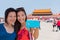 Mother daughter tourists taking travel holiday selfie at Tiananmen Square Beijing, China, Asia. Smiling women taking