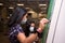 Mother and daughter use the automatic machine to buy the transport ticket in the subway and wear a surgical mask to prevent