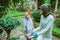 Mother and daughter use pruning shears to care for plants