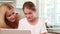 Mother and daughter using laptop together