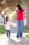 Mother And Daughter Walking Along Path