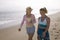 Mother and daughter walking on beach