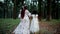 Mother and daughter walking in a deep forest