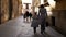 Mother and daughter walking on the medieval street of Palma de Mallorca, Spain