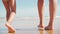 mother with daughter walking sandy ocean beach low tide legs close up. Summer family vacation concept. Summertime active