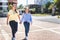 Mother and daughter walking on the sidewalk at the school