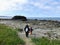 A mother and daughter walking together side by side exploring the beautiful shores of tow hill along the north beach