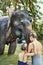 Mother and daughter washing an Asian elephant in a river