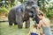 Mother and daughter washing an elephant at an animal sancturay
