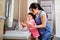 Mother and daughter washing their hands in the bathroom. Care an