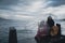 Mother and daughter watching the sea on a cloudy day