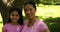 Mother and daughter wearing pink for breast cancer awareness in the park