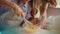 Mother and daughter whisking eggs in mixing bowl on kitchen in slow motion