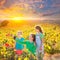 Mother and daughters on autumn vineyard smiling holding grape