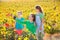 Mother and daughters on autumn vineyard smiling holding grape