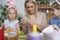 Mother and daughters preparing Easter decorations at home