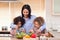 Mother and daughters preparing salad in the kitchen together