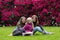 Mother with daughters sitting on a grass