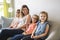 Mother and daughters on sofa at home