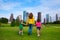 Mother and daughters walking holding hands on city skyline