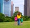 Mother and daughters walking holding hands on city skyline