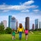 Mother and daughters walking holding hands on city skyline