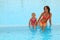 Mother and daugther sitting in open pool