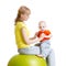 Mother doing gymnastics with baby on fitness ball