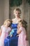 Mother embraces beautiful twin daughters