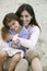 Mother embracing daughter on beach