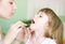 Mother examining little girls throat