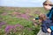 Mother exploring nature with her son by showing him the plants