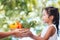 Mother farmer hand giving basket of vegetables to little child