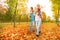 Mother and father carry little daughters in park