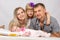 Mother, father, daughter and five-year newborn baby looks in the picture