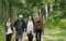 Mother and father enjoying a walk through the woods with daughters