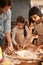 Mother, father and girl with flour for baking cookies in kitchen with dough, rolling pin and teaching with support