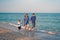 Mother father kid spending time together family vacation Parent dad mom walking with son enjoying sea beach