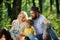 Mother father and little son sit forest picnic. Good day for spring picnic in nature. Explore nature together. Family