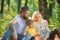 Mother father and little son sit forest picnic. Good day for spring picnic in nature. Explore nature together. Family