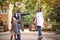 Mother and father with pupil having fun in park after school