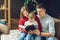Mother and father are reading a Christmas book with their son. Young family with a child celebrates New year
