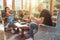 Mother, father and son family sitting together at Sunroom in cozy armchairs and reading books, using laptop or browsing a