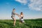 Mother and father swinging son in sunnny summer day