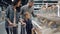 Mother, father and their son are shopping for food in supermarket pointing at plastic boxes on shelves and talking