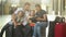 Mother and father with two children are sitting in the waiting room of the railway station or an airport