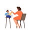 Mother feed her little baby sitting in highchair. Kid eating food.