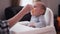 Mother feeding baby girl in highchair