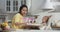 Mother feeding baby in kitchen