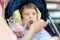 Mother feeding an ice cream little disabled girl in a wheelchair. Child cerebral palsy. Inclusion. Disability